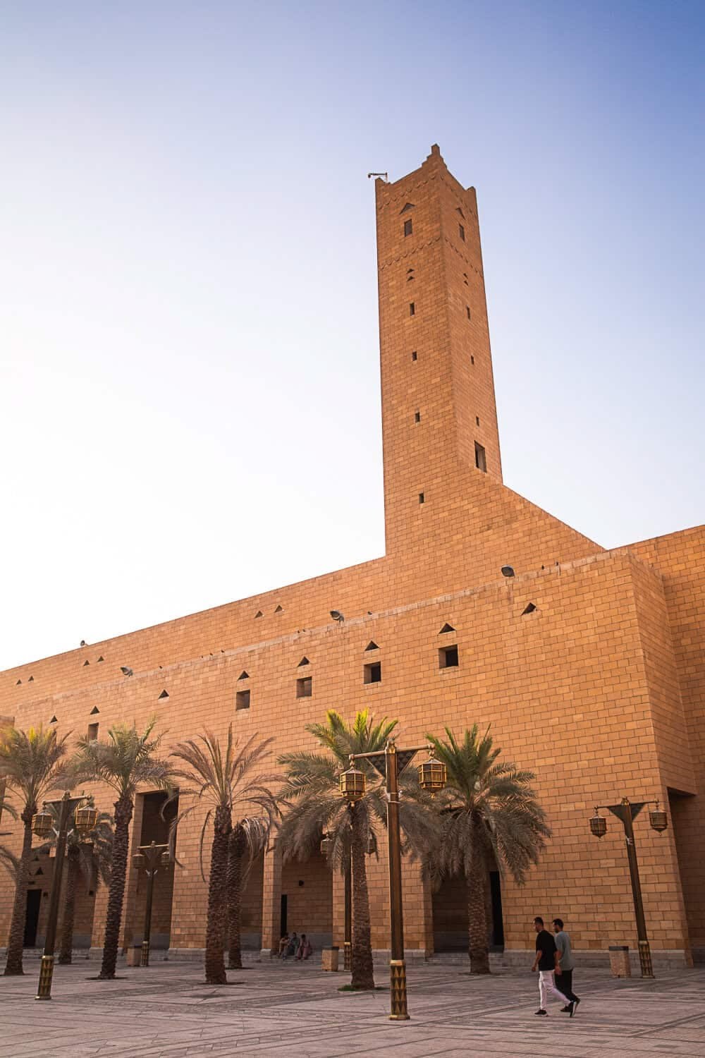 A sand-colored monumental language: Riyadh's older urban identity is rooted in Najdi massing, shade, palm-lined spaces and the civic centrality of the mosque.