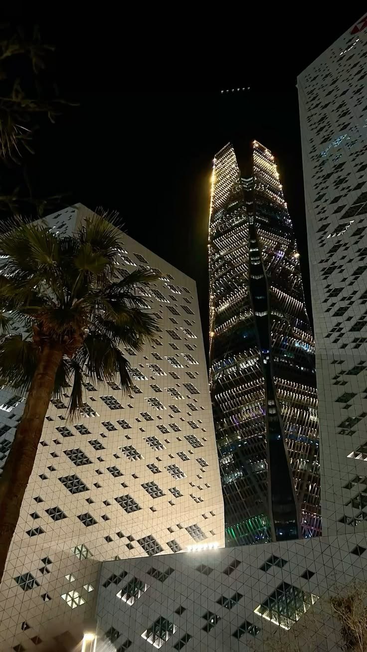 KAFD's illuminated forms at night: Riyadh's new real estate language is financial, vertical, digitally serviced and globally legible.
