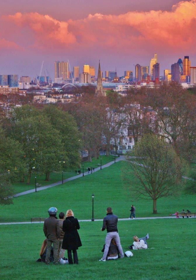 London from the park: a financial skyline rising behind older neighbourhoods and green space. The city's value has always lived in this tension.