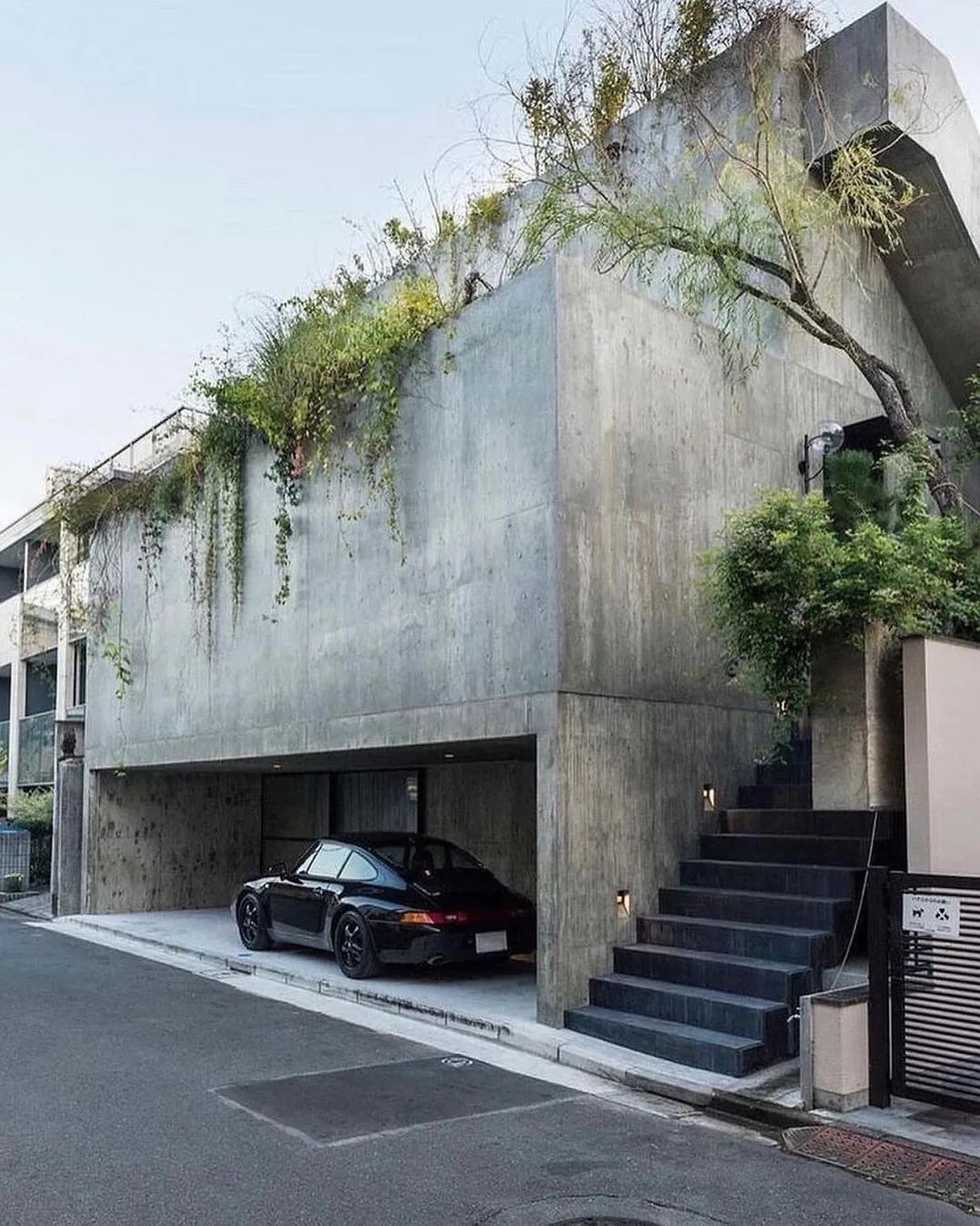 Concrete, greenery and compression: Tokyo residential architecture often turns spatial constraint into atmosphere.